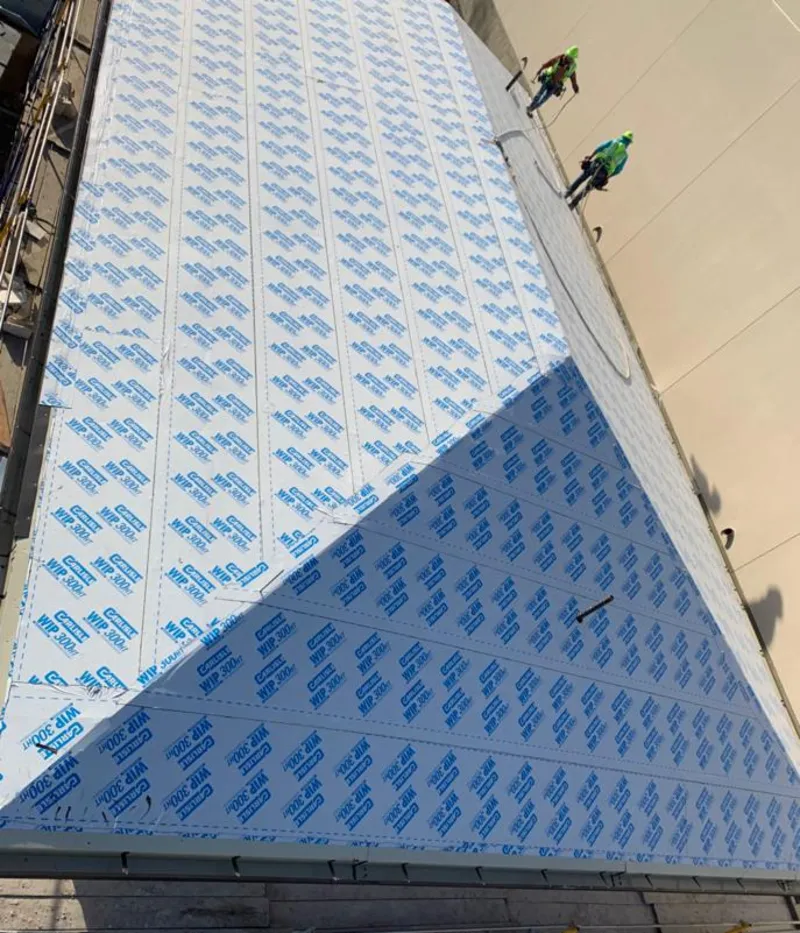 Professional roofers installing underlayment on a metal roof in Oakwood